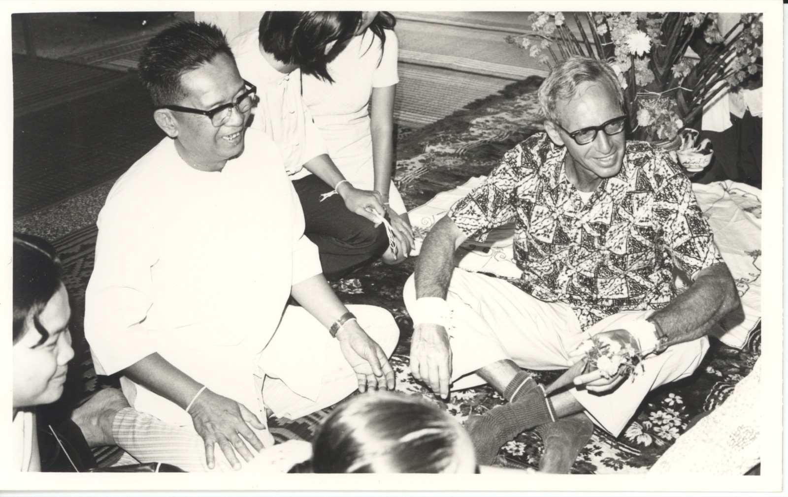 Mr. Bo hosting a baci ceremony with American USAID personnel, 1975